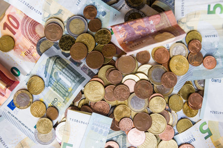 Euro banknotes and coins as a background, closeup of photoの写真素材