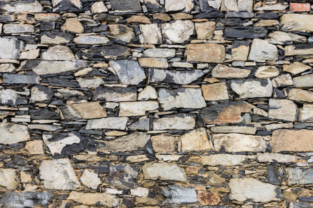 Background of stone wall texture. Closeup of stone wall texture.の写真素材