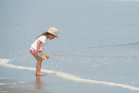 Girl playing on the beachの写真素材
