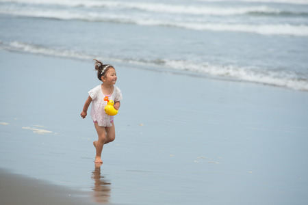 Girl playing on the beachの写真素材