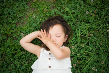 Girl to take a nap in the meadowの写真素材
