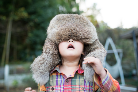 Girl wearing a too large Ushankaの写真素材