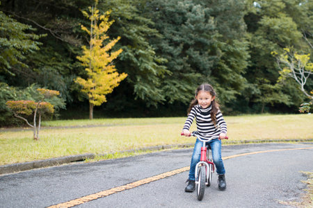 Little girl riding on the bicycleの写真素材