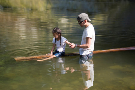 Father and daughter playing in the river