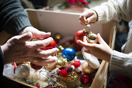 Grandma and granddaughter decorating Christmas treeの写真素材