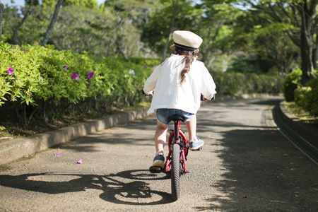 Little girl riding on a bicycleの写真素材