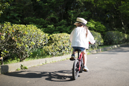 Little girl riding on a bicycleの写真素材
