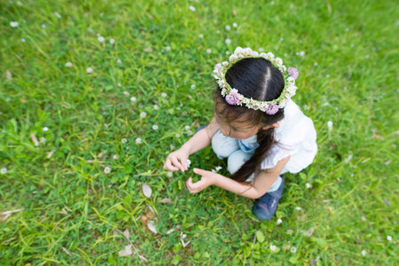 Cute little girl wearing a flower crownの写真素材