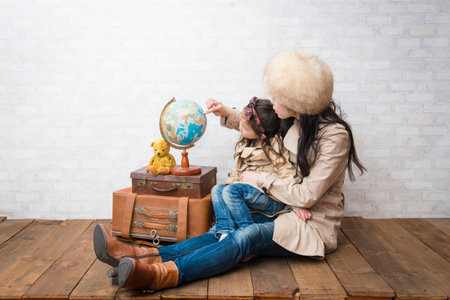 Mother and daughter with globe dreaming about travelingの写真素材