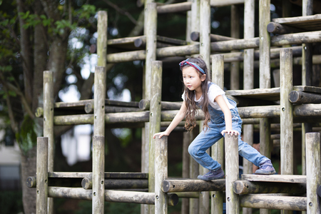 Girl playing on the jungle gymの写真素材