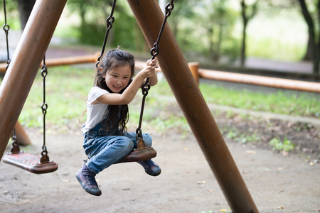 Girl having fun on swingの写真素材