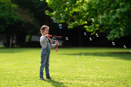 Girl playing with soap bubblesの写真素材