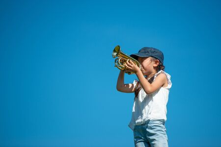 Girl playing trumpetの写真素材
