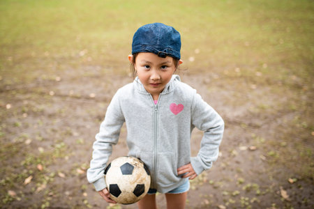 Smiling girl with soccer ball
