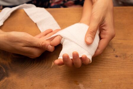 Mother's Hand Taking Care of Child's Handの写真素材