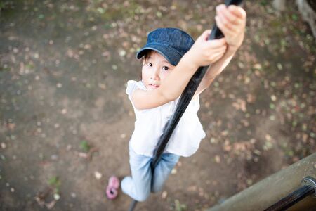 Girl playing with climbing stickの写真素材