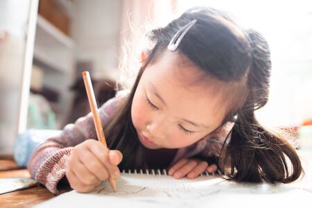 Girl to the graffiti with a pencil on notebookの写真素材