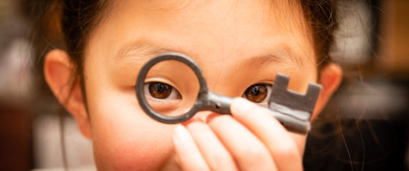 Girl looking at camera holding key
