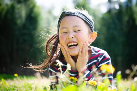 Girl with cheeks in the meadowの写真素材
