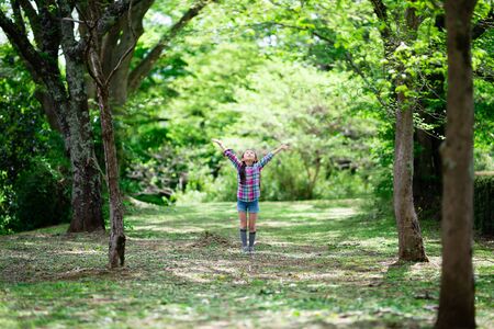 Girl with open arms in the woodsの写真素材