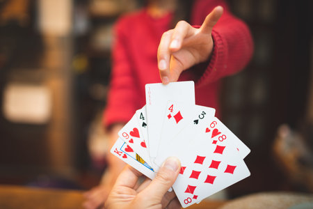 Parent and child playing cards at home