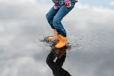 Feet of a child playing in a puddle