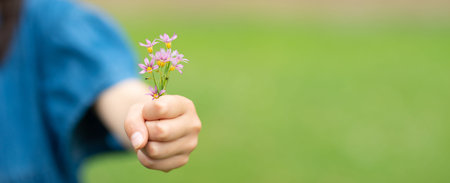 Child holding a small flowers