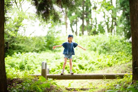 Girl playing in the forest parkの写真素材