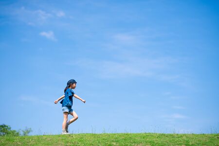 Child walking in the meadowの写真素材
