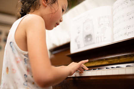 Girl playing the pianoの写真素材