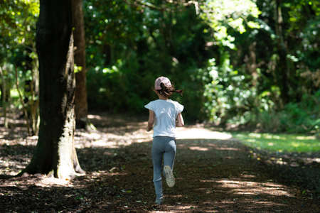 Girl running in nature parkの写真素材
