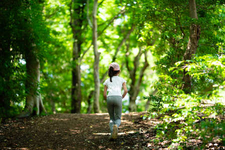 Girl running in nature parkの写真素材