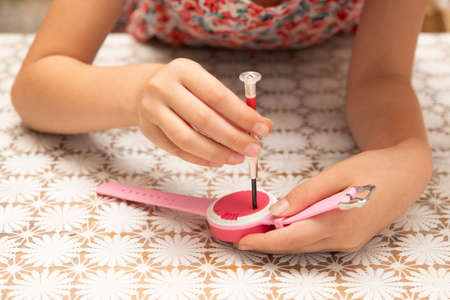 Child repairing a toy with a screwdriverの写真素材