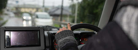Woman driving a car on a rainy dayの写真素材