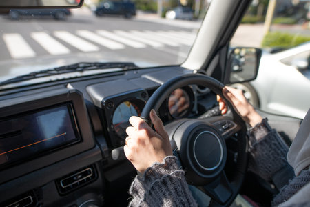 Woman's hand driving a car