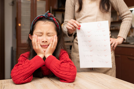Mother scolds daughter with poor testの写真素材