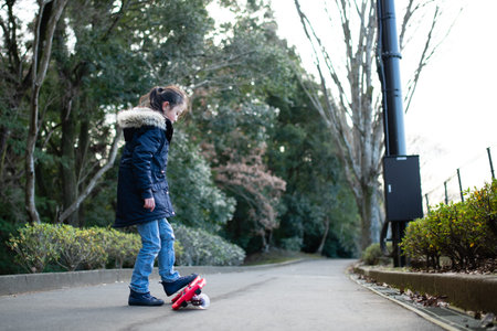 A girl practicing riding on a caster board