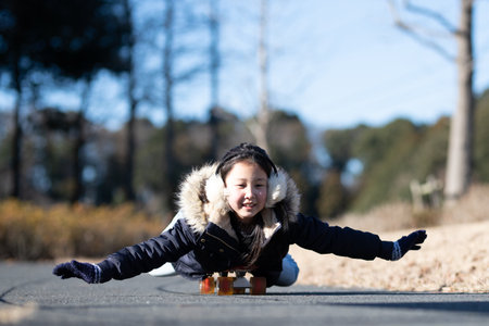 Girl playing on a skateboardの写真素材