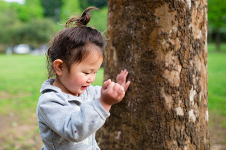 Big tree and toddler girlの写真素材