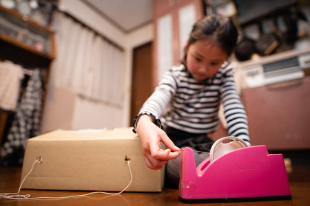 A girl playing with cardboardの写真素材