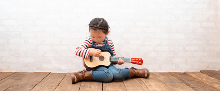 Little girl playing the guitarの写真素材