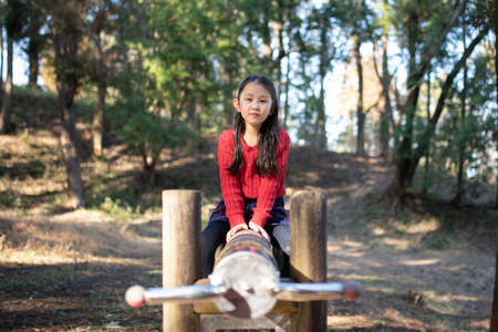 Girl playing in the forest parkの写真素材