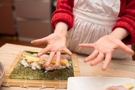 Hands of a child making sushi rollsの写真素材