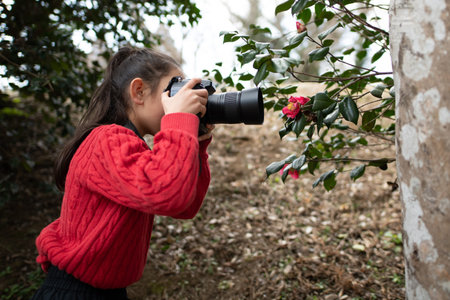 A girl taking a picture with a single-lens reflex camera