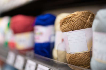 Yarn lined up on the shelvesの写真素材