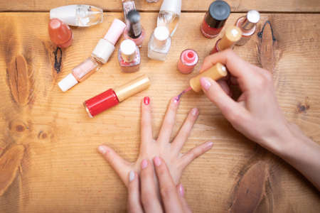 Mother's hand applying nail polish to her daughter's nailsの写真素材
