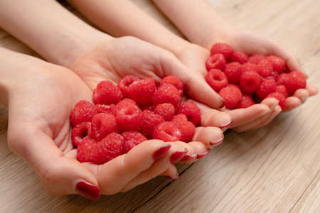 Mother and child holding raspberriesの写真素材