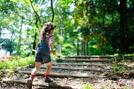 A child walking on the steps of the forestの写真素材
