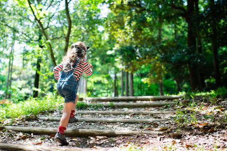 A child walking on the steps of the forestの写真素材
