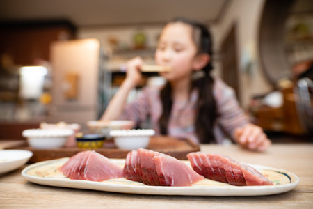 Girl eating sashimi of bonitoの写真素材